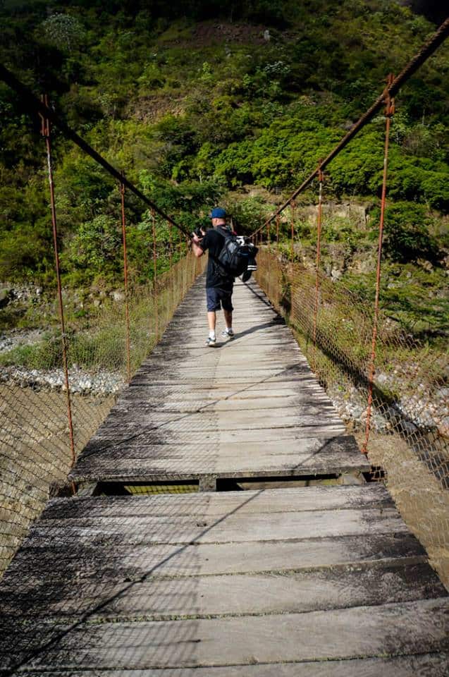 Crossing rope bridge on Machu Picchu adventure trek