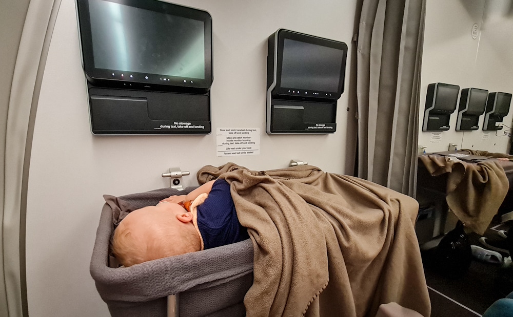 Baby in airplane bassinet
