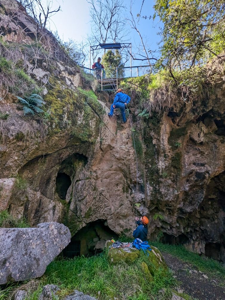 Abseiling down into cave